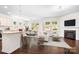 Open-concept living space featuring a modern fireplace, hardwood floors, and bar seating at the kitchen island at 14611 Murfield Ct, Charlotte, NC 28278