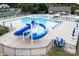 Community pool showcasing a waterslide and outdoor seating surrounded by a safety fence at 14611 Murfield Ct, Charlotte, NC 28278