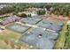 Aerial view of tennis courts, clubhouse, and pool in a residential community at 14611 Murfield Ct, Charlotte, NC 28278
