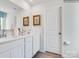 Bathroom featuring double sinks, a white vanity, and decorative accents for a clean and modern look at 1511 River Cane St, Edgemoor, SC 29712
