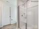 Modern bathroom featuring a glass-enclosed shower, white fixtures, and neutral color palette at 1511 River Cane St, Edgemoor, SC 29712