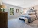 Serene bedroom with soft lighting, a gray upholstered bed, and large windows at 1511 River Cane St, Edgemoor, SC 29712