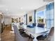 Well-lit dining room featuring stylish chairs, a large table, and elegant blue curtains for a sophisticated touch at 1511 River Cane St, Edgemoor, SC 29712