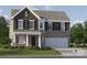 Charming two-story home with a brick and dark siding exterior and an attached two-car garage at 1511 River Cane St, Edgemoor, SC 29712
