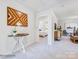 Bright hallway with stylish decor, artwork, and doorway view into a bedroom at 1511 River Cane St, Edgemoor, SC 29712