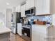 Modern kitchen with white cabinetry, stainless steel appliances, and a stylish backsplash at 1511 River Cane St, Edgemoor, SC 29712