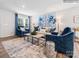 Bright living room with natural light, stylish blue accents, and comfortable seating arrangements at 1511 River Cane St, Edgemoor, SC 29712