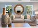 Comfortable living room with stylish decor, a sectional sofa, and large windows offering tree views at 1511 River Cane St, Edgemoor, SC 29712
