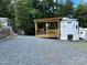 Inviting park model featuring a spacious wooden porch, ideal for enjoying the outdoors at 152 Eagle Dr # 27B, New London, NC 28127