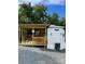 Charming park model with a covered wood porch and gated access, perfect for relaxing outdoors at 152 Eagle Dr # 27B, New London, NC 28127