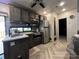 This kitchen offers stainless steel appliances and marble countertops, with wood flooring and gray cabinets at 152 Eagle Dr # 27B, New London, NC 28127