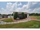 Exterior of the laundromat with manicured lawn and a stone water feature at 152 Eagle Dr # 27B, New London, NC 28127