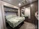 This main bedroom has a closet, lots of storage space, and a nice soft bed at 152 Eagle Dr # 27B, New London, NC 28127