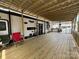Covered wooden patio with outdoor furniture and a camper at 152 Eagle Dr # 27B, New London, NC 28127