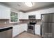 This kitchen features white cabinets, stainless steel appliances, and a stainless steel sink at 1520 28Th Sw St, Hickory, NC 28602