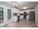 Modern kitchen featuring white cabinets, stainless steel appliances, and access to a deck at 1520 28Th Sw St, Hickory, NC 28602