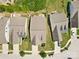 Aerial shot of suburban homes with well-manicured lawns, driveways, and mature trees in a neighborhood at 163 Carmen Way, Lancaster, SC 29720