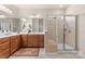Updated bathroom featuring a glass shower enclosure, tiled floors, and a double-sink wooden vanity at 163 Carmen Way, Lancaster, SC 29720