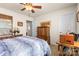 Cozy bedroom featuring a wooden dresser, mirror, and a ceiling fan for added comfort at 163 Carmen Way, Lancaster, SC 29720