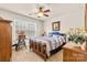 Bedroom with a wooden bed frame, ceiling fan, and window with blinds at 163 Carmen Way, Lancaster, SC 29720