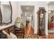 Inviting hallway with hardwood floors, a grandfather clock, and decorative mirror at 163 Carmen Way, Lancaster, SC 29720