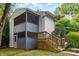 Exterior view of a two-story home featuring a screened-in porch and wooden stairs at 1638 Hunters Trl, Rock Hill, SC 29732