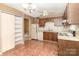 Kitchen with white appliances, oak cabinets, vinyl flooring, and pantry at 1638 Hunters Trl, Rock Hill, SC 29732