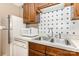 Close-up of kitchen sink, faucet, microwave, dishwasher, and backsplash at 1638 Hunters Trl, Rock Hill, SC 29732