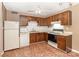Kitchen featuring white appliances, oak cabinets, vinyl flooring, and overhead lighting at 1638 Hunters Trl, Rock Hill, SC 29732