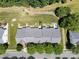 Aerial shot of property featuring well-maintained landscaping, a backyard patio, and adjacent green space at 1644 Backcreek Ln, Gastonia, NC 28054