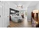Bedroom with black accent wall, ceiling fan and light wood floors at 1644 Backcreek Ln, Gastonia, NC 28054