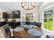 Cozy dining area with a wood table, modern lighting, and a view into the kitchen, perfect for Gathering meals at 1644 Backcreek Ln, Gastonia, NC 28054
