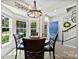 Bright dining room with a round wood table, view of the blue front door, and stairs to the upper level at 1644 Backcreek Ln, Gastonia, NC 28054