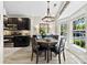 Well-lit dining area with a round table, dark wood chairs, and seamless flow into the kitchen at 1644 Backcreek Ln, Gastonia, NC 28054
