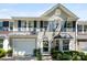 Charming two-story townhome with a light gray exterior, a black metal roof accent, and an attached garage at 1644 Backcreek Ln, Gastonia, NC 28054