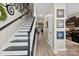 Inviting entryway with a staircase, light wood floors, and decorative wall art leading into the home's living spaces at 1644 Backcreek Ln, Gastonia, NC 28054