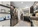 Modern kitchen with stainless steel appliances, dark cabinetry, granite countertops, and stylish floating shelves at 1644 Backcreek Ln, Gastonia, NC 28054