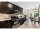 Well-equipped kitchen with modern appliances, dark cabinetry, and a breakfast nook dining area at 1644 Backcreek Ln, Gastonia, NC 28054