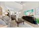 Bright living room with high ceilings, light wood floors, a large screen TV, and access to a kitchen at 1644 Backcreek Ln, Gastonia, NC 28054
