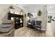 Open living area with a built-in display cabinet and a view into the modern kitchen and front entry at 1644 Backcreek Ln, Gastonia, NC 28054
