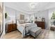 Spacious main bedroom with tray ceilings, light wood floors, and lots of natural light at 1644 Backcreek Ln, Gastonia, NC 28054