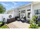 Cozy patio area with outdoor seating, decorative plants, and a privacy fence at 1644 Backcreek Ln, Gastonia, NC 28054
