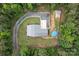Aerial view of property featuring a white house, pool, detached lounge area, circular driveway, and forest at 213 Genesis Pl, Cleveland, NC 27013