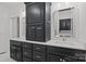 Modern bathroom featuring double sinks, bright quartz counters, and elegant dark toned cabinetry at 213 Genesis Pl, Cleveland, NC 27013