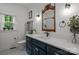 Bright bathroom featuring a blue vanity, sleek fixtures, and black and white tile flooring at 213 Genesis Pl, Cleveland, NC 27013