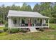 Attractive home with a welcoming front porch that features comfortable seating and beautiful landscaping at 213 Genesis Pl, Cleveland, NC 27013
