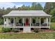 Charming home features a welcoming front porch, complete with a swing, rocking chairs, and outdoor seating at 213 Genesis Pl, Cleveland, NC 27013