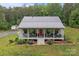 Beautiful home offers a spacious front porch, perfect for relaxing and enjoying the surrounding landscape at 213 Genesis Pl, Cleveland, NC 27013
