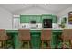 Modern kitchen with green cabinetry, stainless appliances, and seating at the peninsula at 213 Genesis Pl, Cleveland, NC 27013
