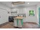 Bright laundry room featuring modern washer and dryer, brick floors and a butcher block island at 213 Genesis Pl, Cleveland, NC 27013